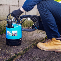 Tsurumi LB Submersible Pump, Compact and durable pump for efficient water removal in tough environments, pictured with man.