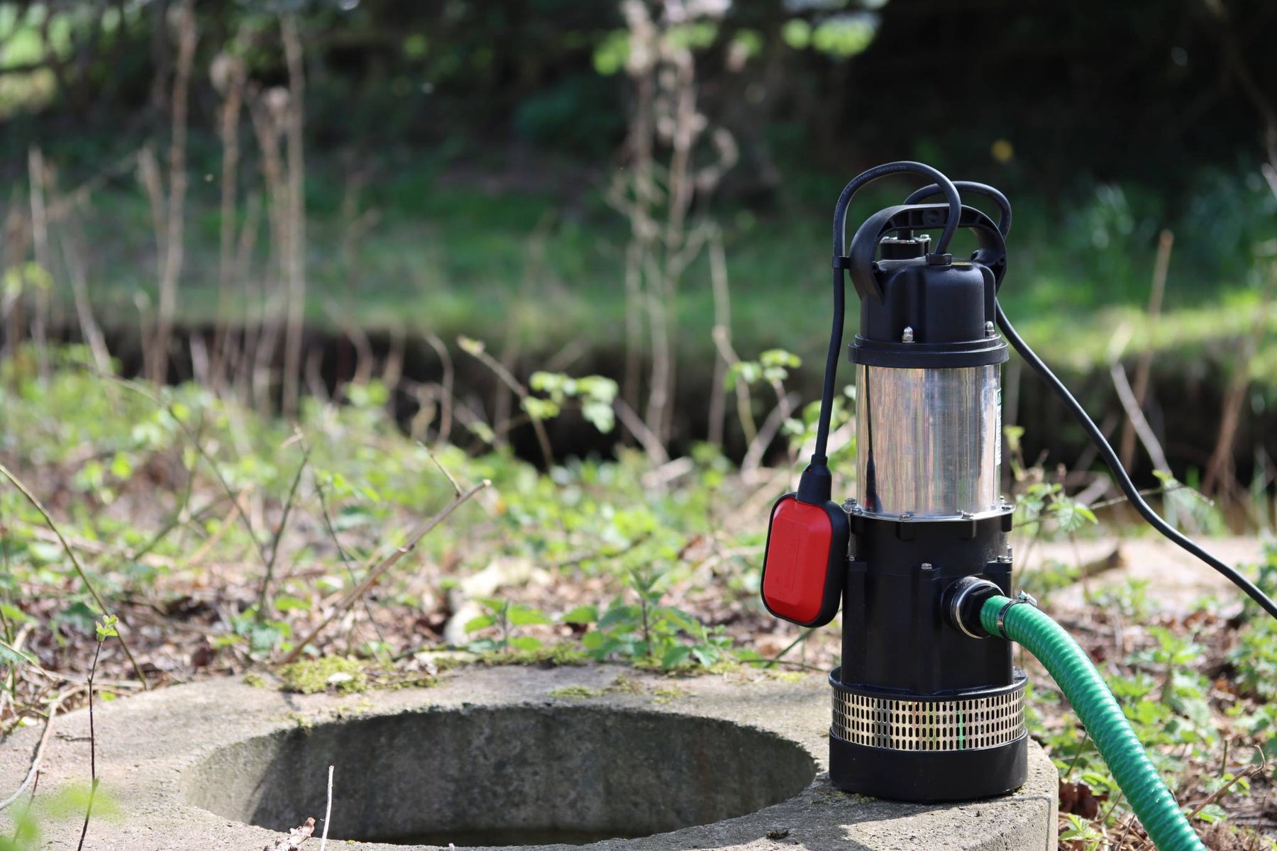 APP MVH Well pump pictured by a well