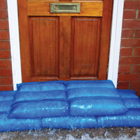 blue hydro sacks stopping flood water at front door